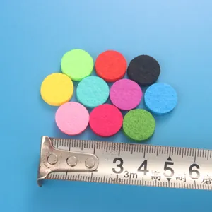 Colorful 18mm round felt pads for essential oil diffuser bracelet shown with a tape measure