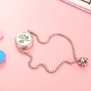 Detail of rose pattern diffuser locket on adjustable stainless steel bracelet