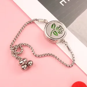 Detail of adjustable silver diffuser bracelet with rose filigree and green aroma pad