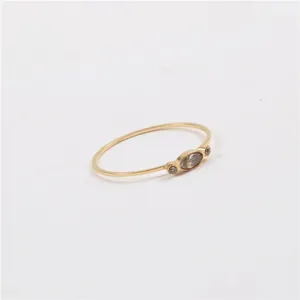 Minimalist gold thin ring with marquise and round grey zircon stones in a three-stone design