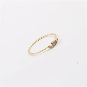 Minimalist gold thin band ring featuring an oval brown zircon and side accent stones