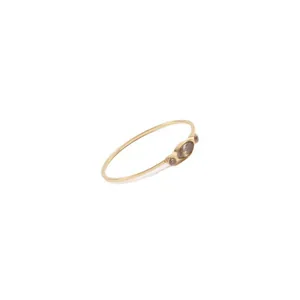 Minimalist gold ring featuring three smokey brown zircon stones on a slim band