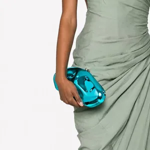 Detailed view of an asymmetric electric blue acrylic clutch with metallic wave texture