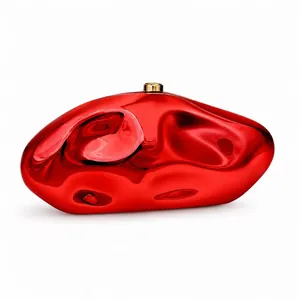 Polished red acrylic pebble-shaped evening clutch bag with gold metallic lock closure