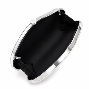Internal view of silver acrylic clutch bag showing black lining and snap closure