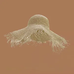 Detailed close-up of natural beige straw hat featuring frayed edges and woven texture