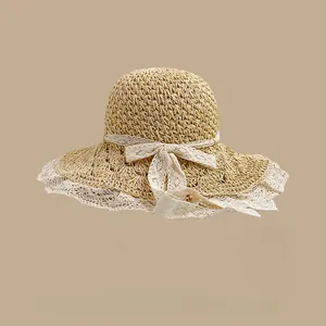 Close-up of hand-woven straw hat texture with white lace ribbon and delicate bow detail