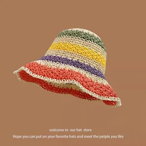 Detail of multi-colored hand-woven rainbow straw hat with tight texture and wide brim