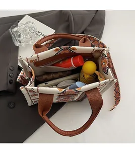 Spacious interior of canvas tote bag with geometric patterns and leather handles