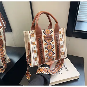 Close-up of retro ethnic canvas tote bag with geometric patterns and leather handles