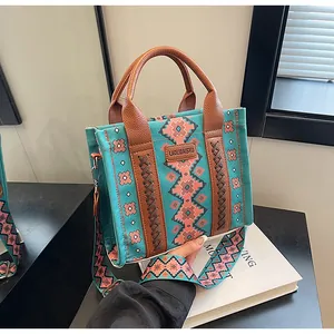 Detailed close-up of ethnic canvas tote bag with geometric patterns and leather handles