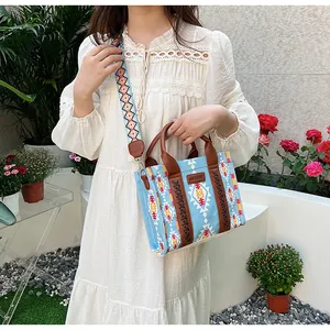 Bohemian canvas tote bag featuring ethnic patterns and a colorful woven shoulder strap