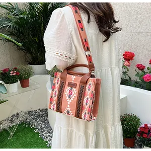 Ethnic style canvas tote bag with geometric patterns shown in a lifestyle outdoor setting