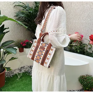 Close-up of geometric ethnic canvas tote bag with wide patterned shoulder strap