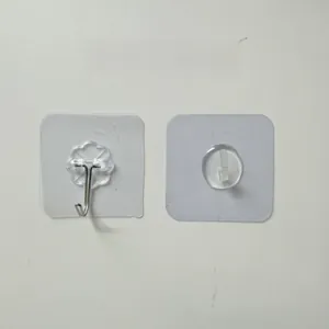 Detail of transparent adhesive wall hooks and metal flower base hangers for bathroom