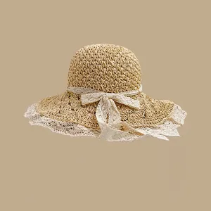 Straw sun hat with wide brim, delicate white lace trim and an elegant bow decoration