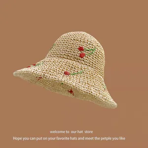 Beige wide brim straw sun hat featuring delicate red and green cherry floral embroidery