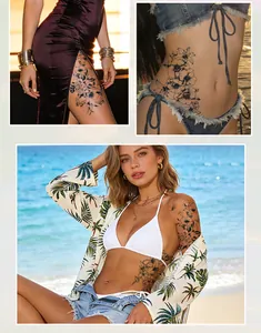 Artistic black floral herbal juice temporary tattoos applied on model at the beach