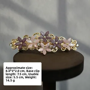 Detail of vintage flower hair clip with purple rhinestones and sizing 8.0x3x2.0cm