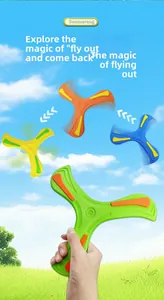 Action shot of four colorful EVA foam boomerangs flying over a bright sunny grass field