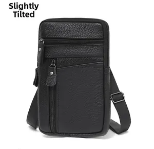 Detail of black litchi grain leather waist bag featuring three secure zipper compartments