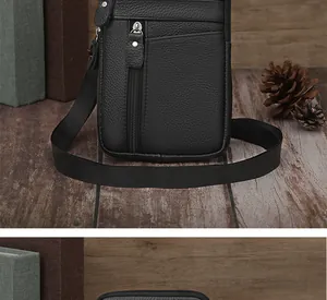 Detail view of black lychee leather men's cross-body bag with multiple zipper pockets