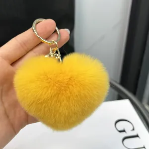 Faux rabbit fur heart-shaped keychain in bright yellow with gold metal clasp