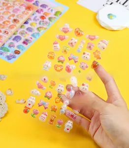 Close-up of 3D embossed cartoon stickers with cute rabbit and fruit patterns for DIY crafts