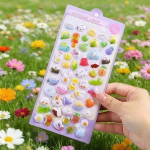 Detailed view of 3D puffy stickers with cute animals and fruits held outdoors
