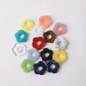 Detailed view of colorful marble textured acrylic flower charms for jewelry making