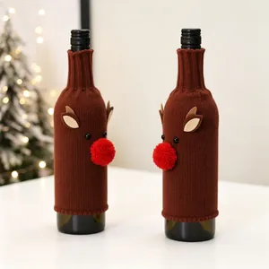 Close-up of reindeer knitted wine bottle covers with red pom-pom noses for Christmas decor