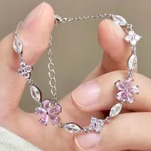 Detail of a silver bracelet with pink flower crystals and adjustable extension chain