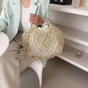 Beige woven mesh tote bag with round wooden handles and white drawstring inner pouch