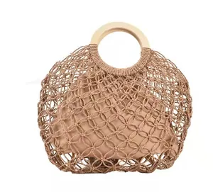 Brown mesh woven handbag with round wooden handles and khaki inner pouch for summer beach