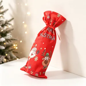 Detail of red fabric Christmas wine bottle bag with Santa print and ribbon closure