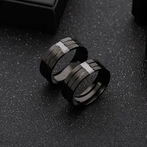 Men's black stainless steel ring with brushed finish and white inlay on dark starry background