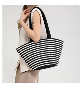 Large capacity striped woven tote bag shown on model with black shoulder straps