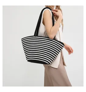 Close-up of black and white striped cotton knit tote showing woven texture and handles