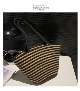 Detailed view of black and khaki striped knit tote bag with shoulder straps on table
