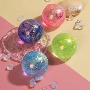 Close-up of sensory glitter balls in four colors with sparkling sand-like filler inside
