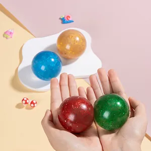 Close-up of four colorful glitter stress balls in blue, gold, red and green shades