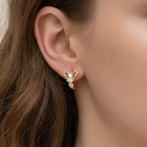 Elegant 18K gold-plated butterfly earrings with zircons shown on a female model