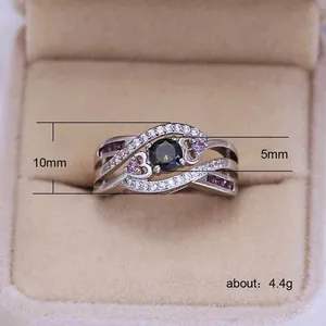 Silver amethyst ring with pink heart stones and white zircons in a jewelry box