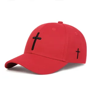 Detail of red baseball cap featuring premium black cross embroidery on twill fabric