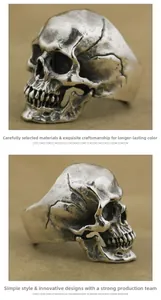 Macro detail of vintage punk skull ring with weathered silver finish and ruby eye accents
