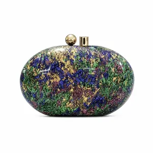 Detailed close-up of marble texture acrylic evening clutch with gold ball clasp hardware