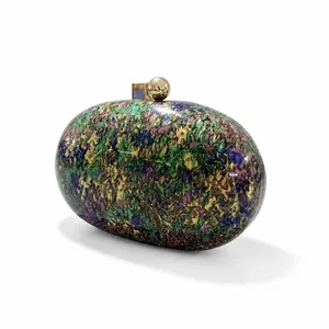 Detailed macro view of the colorful marble textured surface and golden ball clasp
