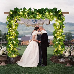 Solar LED ivy garland lights on a wooden wedding arch for outdoor garden decor