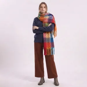 Close-up of rainbow plaid scarf with soft mohair texture and long fringe tassels