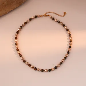 Detail of faceted tiger eye beads and gold metal beads with lobster clasp and chain